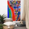 A room with a large painting of flowers and a plant