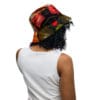 A person wearing a white shirt and a colorful hat.