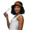 A woman holding glasses wearing a colorful hat.