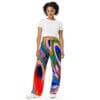 A woman wearing colorful pants and a white shirt.