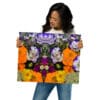 A woman holding up a picture of flowers.
