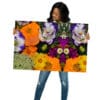 A woman holding up a large picture of flowers.