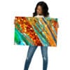 A woman holding up an art work in front of her face.