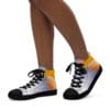 A person wearing silver sneakers with sun on them.