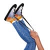A person holding onto the laces of their shoes