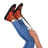 A person is holding onto the laces of their shoes.