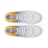 A pair of white shoes with yellow and orange accents.