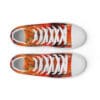 A pair of shoes with an orange and black pattern on them.