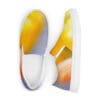 A pair of shoes with yellow and white background
