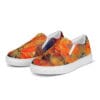 A pair of shoes with an orange and yellow painting on them.