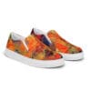 A pair of shoes with an orange and red painting on them.