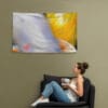 A woman sitting on the couch with her feet up.