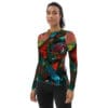 A woman wearing a long sleeve shirt with colorful designs.