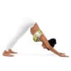 A woman in white pants and a yellow top doing yoga.