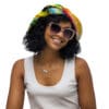 Woman in sunglasses and colorful hat.