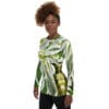 A woman wearing a long sleeve shirt with a plant design.