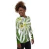 A woman wearing a long sleeve shirt with a plant design.
