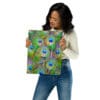 Woman holding vibrant peacock feather print.
