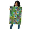Woman holding vibrant peacock feather print.