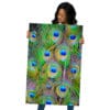 Woman holding vibrant peacock feather print.