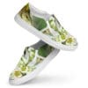 A pair of shoes with white flowers and green leaves