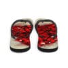 A pair of flip flops with red rose petals on them.