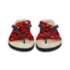 A pair of red flip flops on top of a white surface.