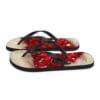 A pair of flip flops with red flowers on them.