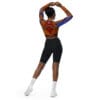 Woman in tie-dye top and shorts, back view.