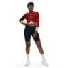 Woman in pomegranate crop top and shorts.