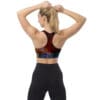 Woman in colorful sports bra and leggings.