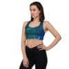 Woman in galaxy print sports bra and leggings.