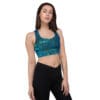 Woman in teal galaxy sports bra and leggings.