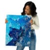 Woman holding blue abstract art print.