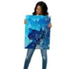 Woman holding blue abstract art print.