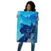 Woman holding blue abstract art print.