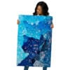 Woman holding blue crystal artwork.