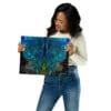 Woman holding vibrant galaxy art print.