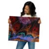 Woman holding vibrant butterfly wing art.