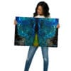 Woman holding vibrant nebula artwork.