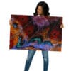 Woman holding vibrant butterfly wing art.