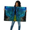 Woman holding vibrant blue abstract art.