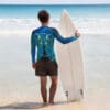 Surfer with surfboard at the beach.