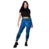 Woman wearing teal galaxy leggings.