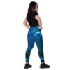 Woman in blue galaxy leggings, back view.