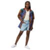 Woman in colorful shirt and denim shorts.