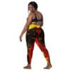 Woman in colorful leggings and black top.
