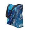 Blue abstract tote bag with black straps.