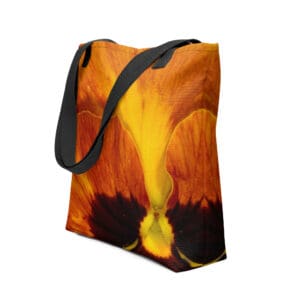 Orange pansy tote bag with black straps.