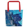 Blue crystal tote bag with red handles.